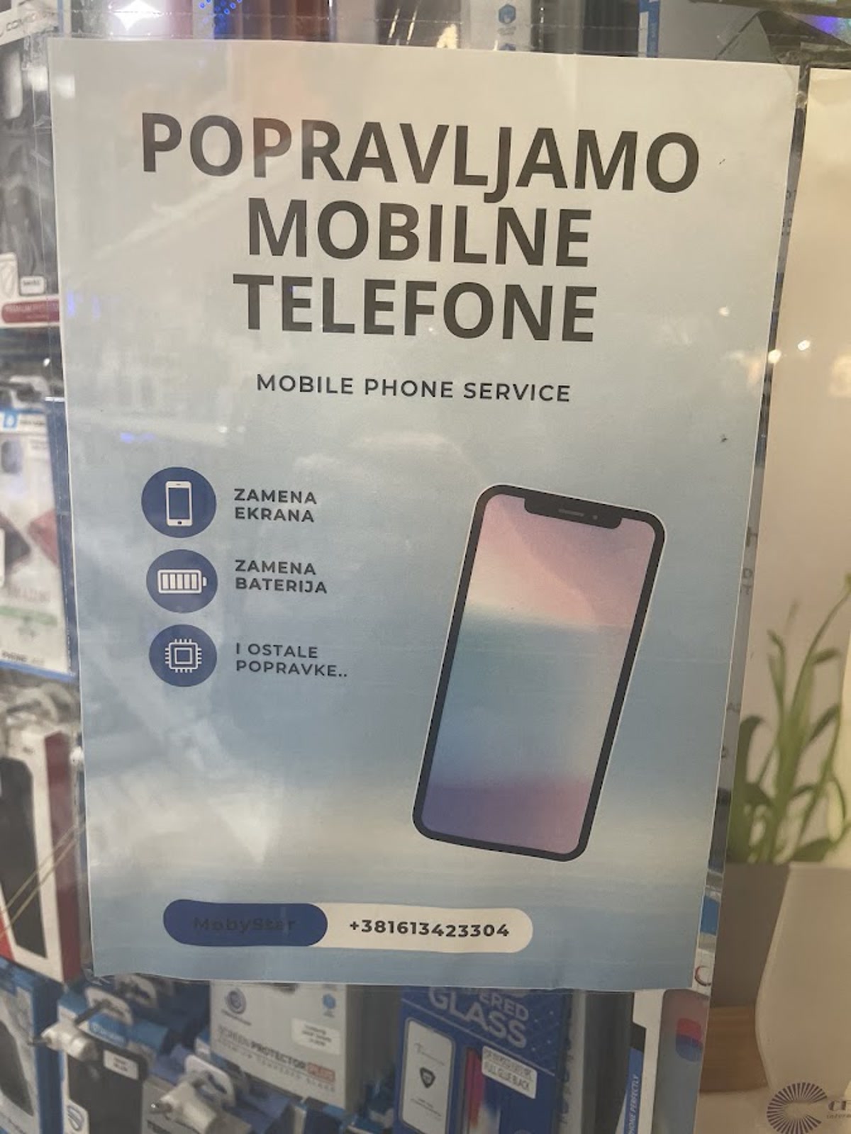Photographed MobyStar service poster listing screen, battery and other mobile repairs